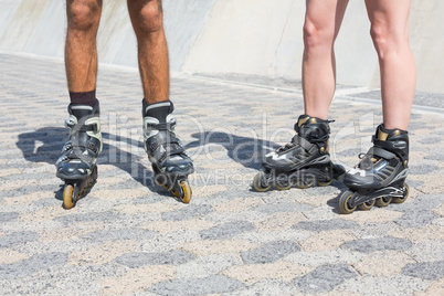 Fit couple rollerblading together on the promenade