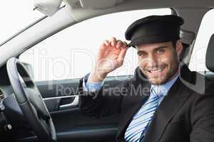 Handsome chauffeur smiling at camera