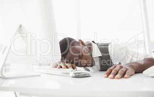 Tired businessman sleeping on keyboard