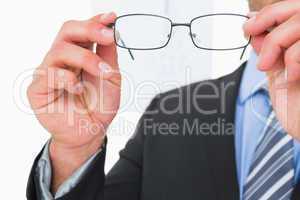 Businessman holding eyeglasses