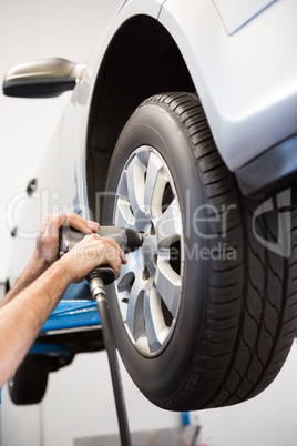 Mechanic adjusting the tire wheel