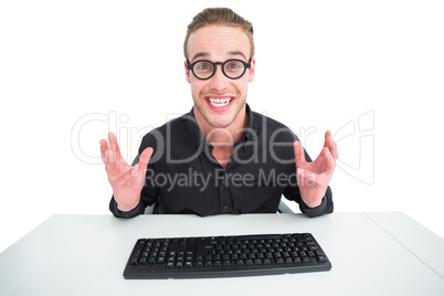 Businessman in shirt making a face at desk