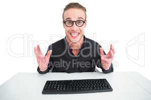 Businessman in shirt making a face at desk