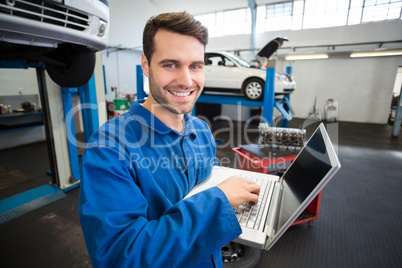 Mechanic using a laptop to work