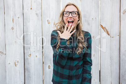 Surprised blonde in striped shirt gesturing