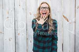 Surprised blonde in striped shirt gesturing