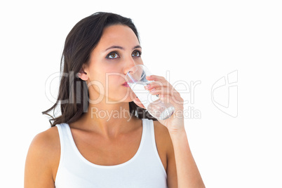 Pretty brunette drinking glass of water
