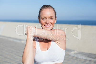 Fit blonde warming up on the pier