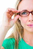 Pretty blonde holding her red reading glasses