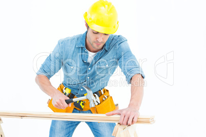 Carpenter using hammer on wood