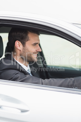 Happy businessman in the drivers seat