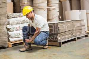 Worker with sprained ankle on the floor