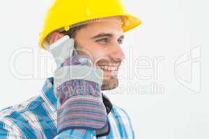 Happy male carpenter using cellphone