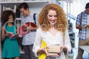 Student carrying small pile of books