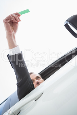 Businessman smiling and holding card Businessman smiling and holding card