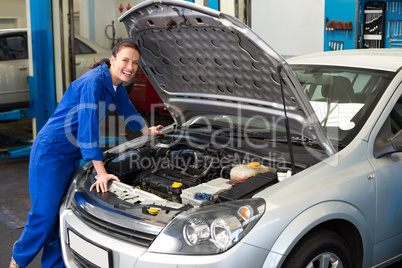 Smiling mechanic looking at camera