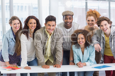 Fashion students smiling at camera together