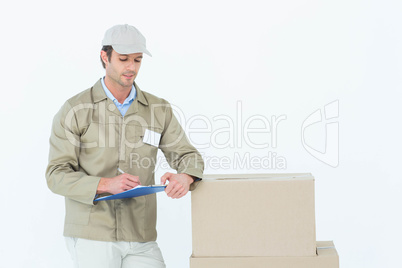 Delivery man writing on clipboard