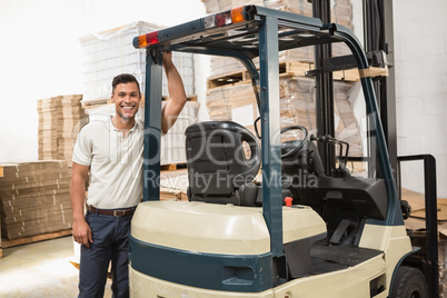 Manual worker leaning against the forklift