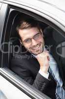 Happy businessman in the drivers seat