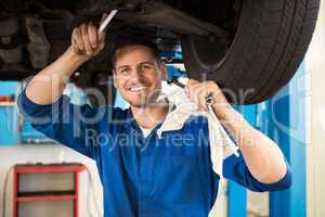 Mechanic examining under the car