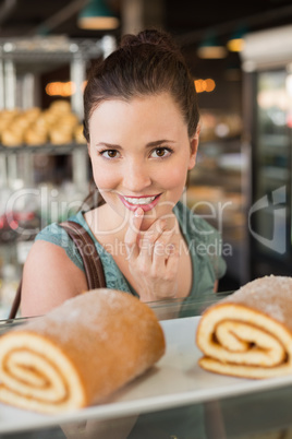 Pretty brunette looking at swiss roll