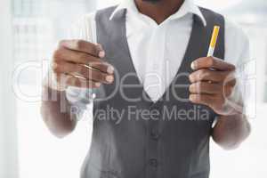 Casual businessman holding cigarettes