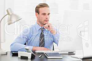 Businessman thinking with hand on chin