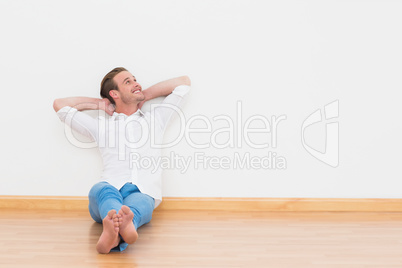 Casual man sitting on floor at home