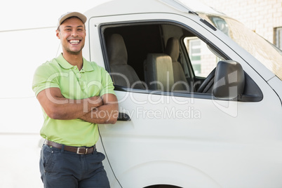 Smiling man standing against delivery van