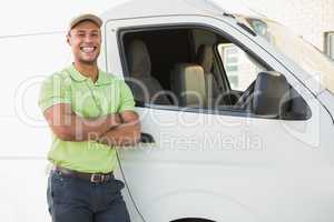 Smiling man standing against delivery van
