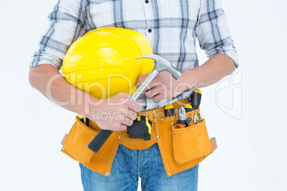 Technician holding hammer and hard hat