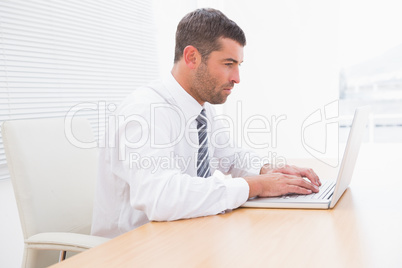 A serious businessman working at desk