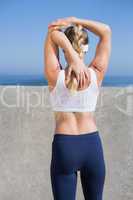 Fit blonde stretching on the pier