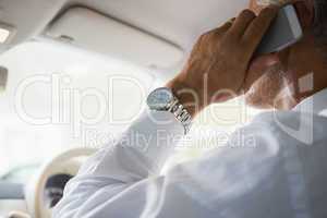 Close up of a businessman on the phone in his car