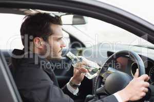 Young businessman driving while drunk