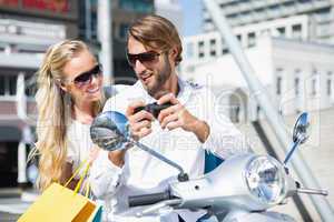 Attractive couple riding a scooter