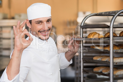 Positive baker checking freshly baked bread