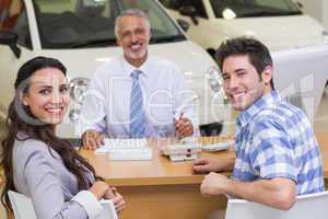 Portrait of smiling salesman and his clients