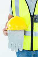 Construction worker holding gloves and hardhat