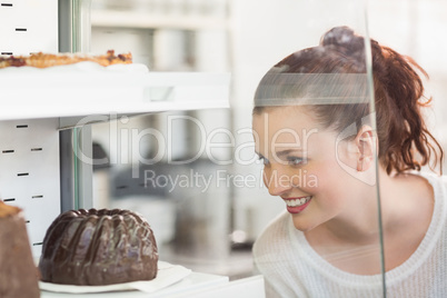 Pretty brunette looking at cake Pretty brunette looking at cake