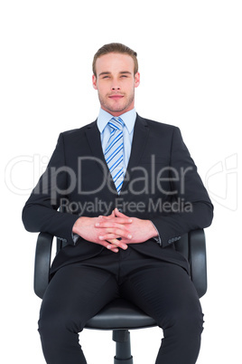 Stern businessman sitting on an office chair