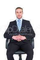 Stern businessman sitting on an office chair