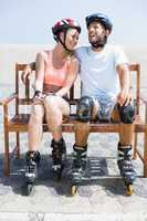 Fit couple getting ready to roller blade