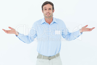 Businessman shrugging shoulders over white background