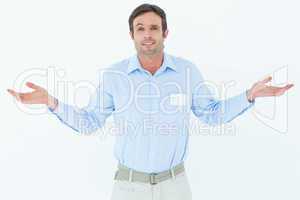 Businessman shrugging shoulders over white background