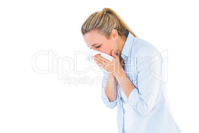 Pretty blonde blowing nose on tissue