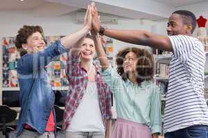 Fashion students high fiving together