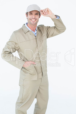 Happy delivery man holding cap Happy delivery man holding cap
