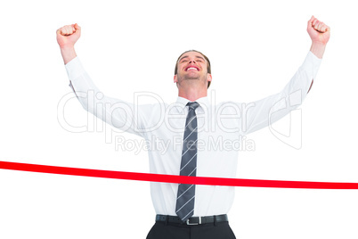 Happy businessman crossing the finish line